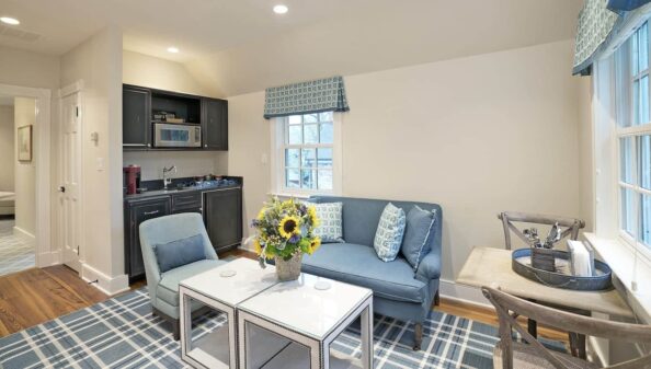 Farm House sitting area with blue accents next to kitchenette